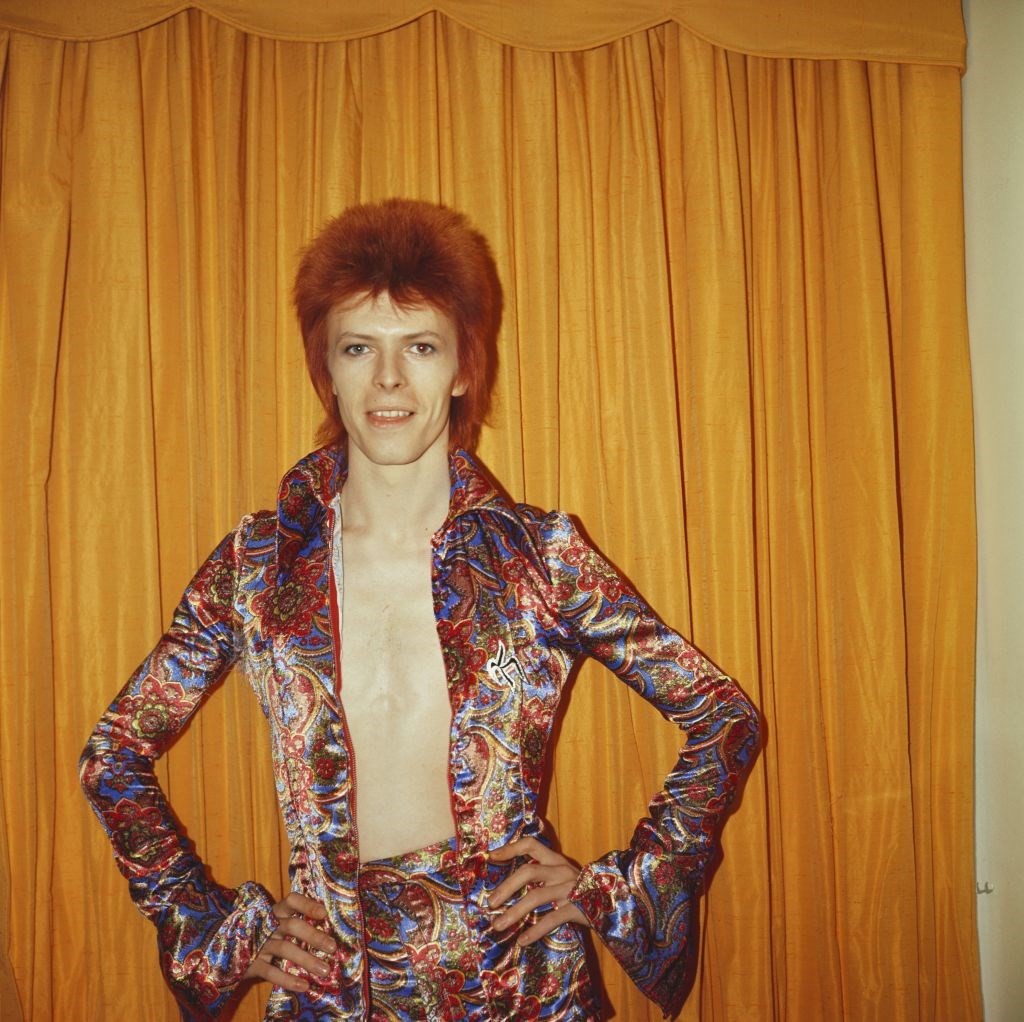 David Bowie poses for a portrait dressed as Ziggy Stardust i