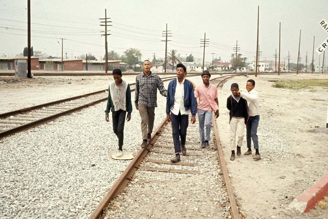 Young men hang out near Simon Rodia&#39;s Watts Towers, 1966