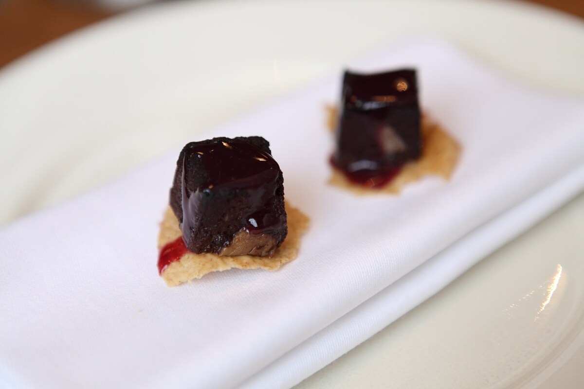 Blood cakes with damson on rye crackers