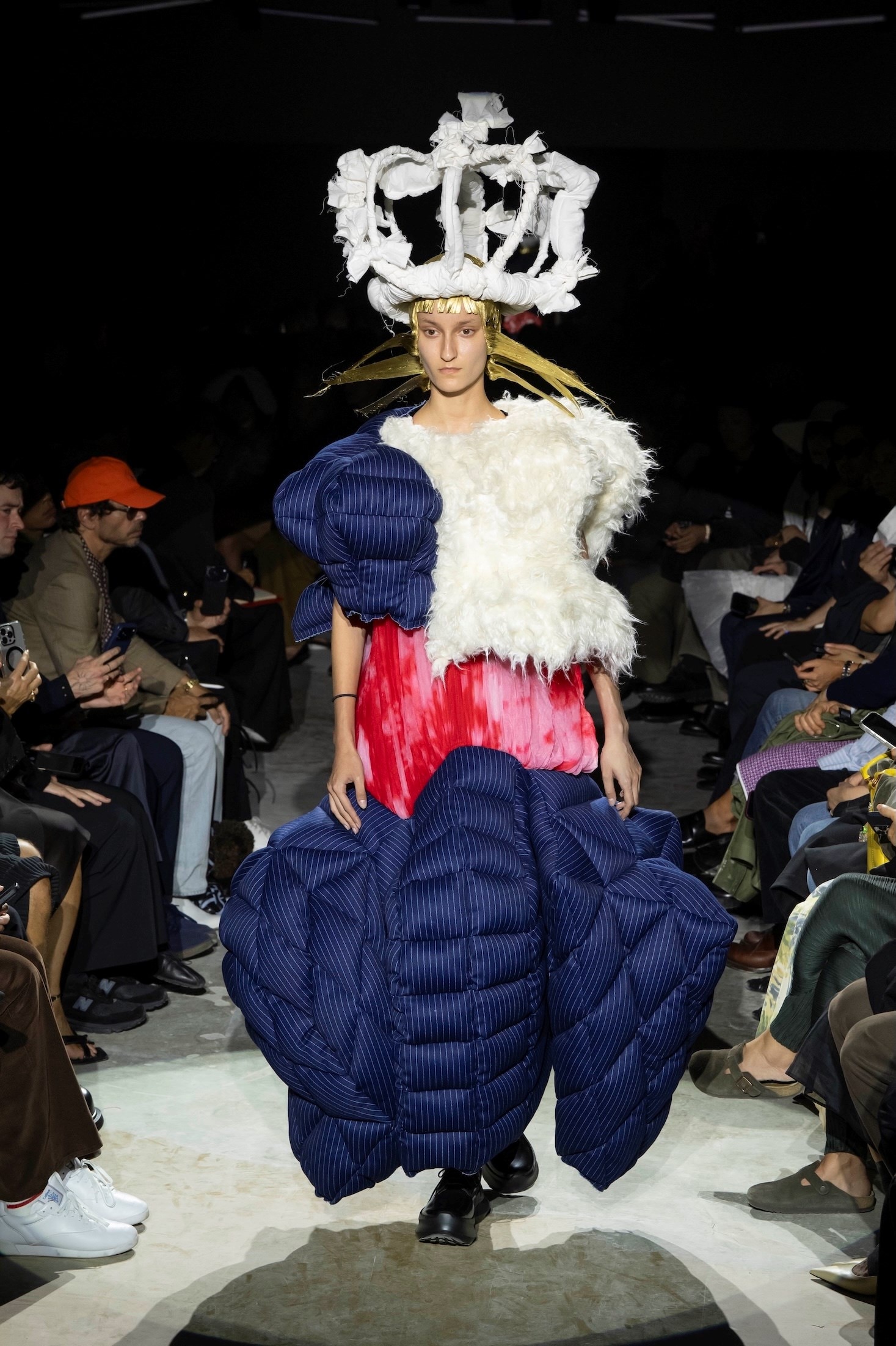 Comme des Garçons SS27 monumental denim dress with an exaggerated padded skirt and gold dome headpiece