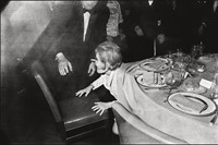 Marlene Dietrich emerging from beneath the table