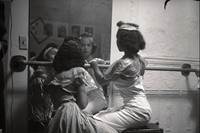 Eve Arnold, Two young black models check their mak