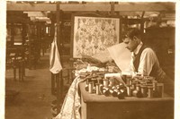 Reginald Warner inspecting silk thread. Note-flora