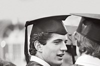 John F. Kennedy Jr. chats with a classmate at his graduation