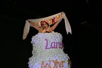 Performance artist The-O Adams inside the Lanvin cake