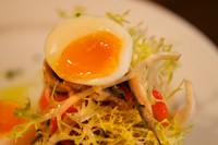White anchovies, soft boiled egg, peppers and salad on toast