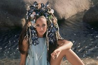 In a shell headdress worn to complement the warm Mediterrane
