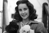 Elizabeth Taylor stands with her brother and their dog in a 