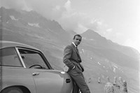 Sean Connery relaxes on the bumper of his Aston Martin DB5 d
