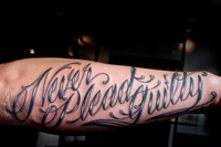 Never Plead Guilty Tattoo by Scott Cambell