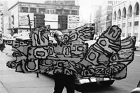 Claes Oldenburg carrying Street Sign (1960) to the Reuben Ga