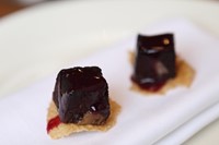 Blood cakes with damson on rye crackers