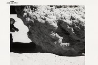 Charles Duke, John Young examines a lunar boulder, Apollo 16
