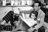 Humphrey Bogart and Lauren Bacall with their pet boxer at ho
