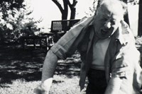 Alfred Hitchcock plays with one of his Sealyham Terriers. Ho