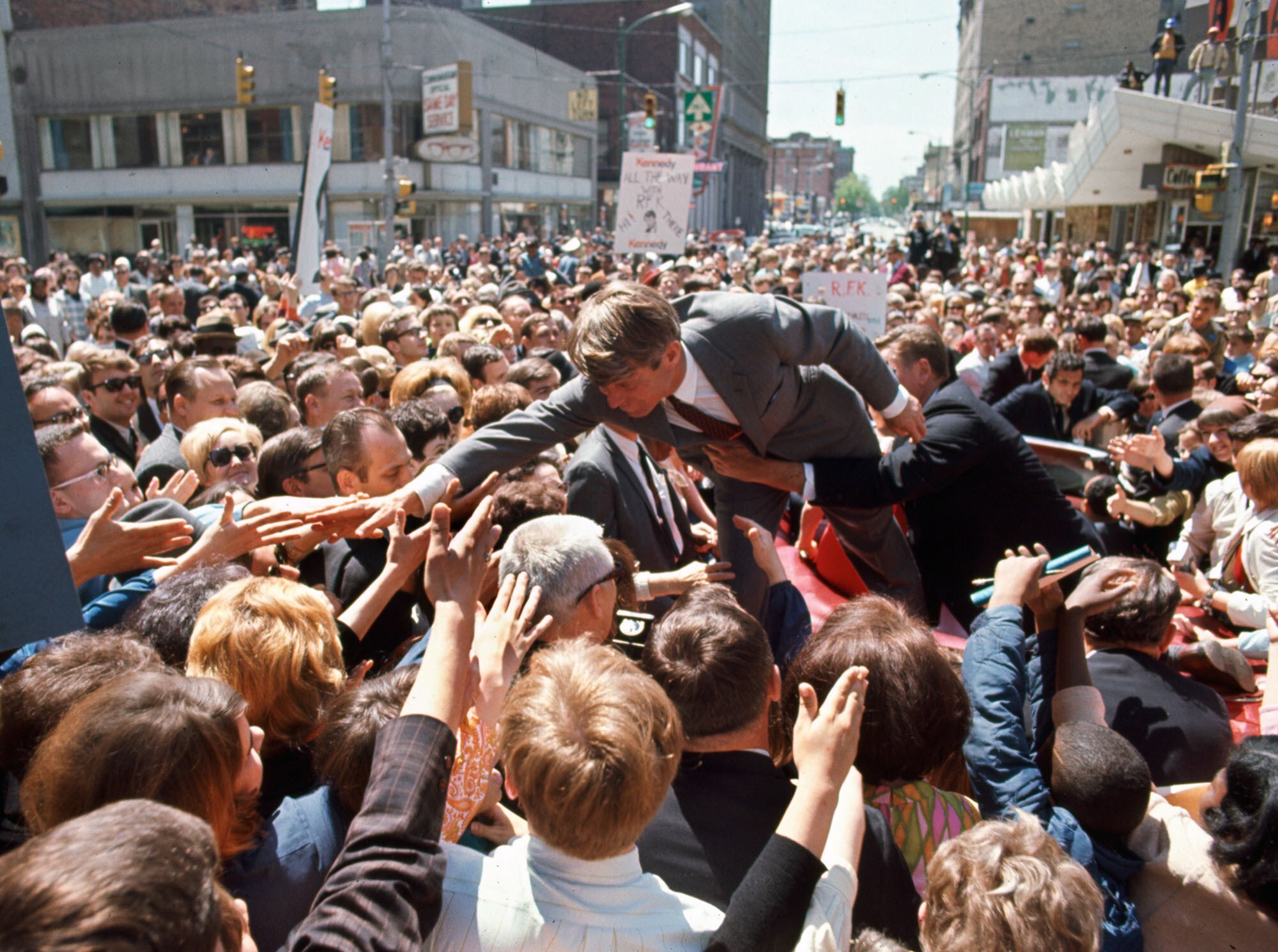&#169; Bill Eppridge. Bobby Kennedy with a crowd in a Midwest cit