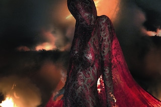 Aymeline wears lace dress and head mask Joan A/W98
