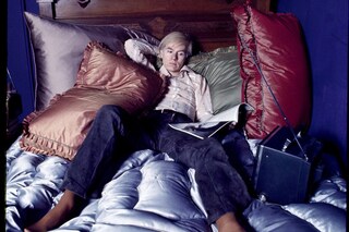 Andy Warhol on the bed of his home in New York