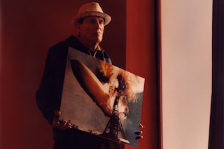 Portrait of Kenneth Anger with his print of the Hindenburg