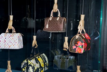 A visitor looks at handbags on display during the Louis Vuitton Voyages  exhibition at the National Museum of China in Beijing, China, 31 May 2011.  A Stock Photo - Alamy