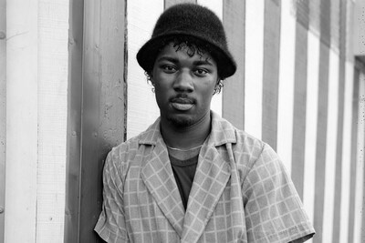 Dawoud Bey. ‘A Young Man Leaning on a Striped Wall’, Rochest