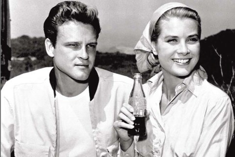 Actress Grace Kelly drinking Coca-Cola and actor John Ericso