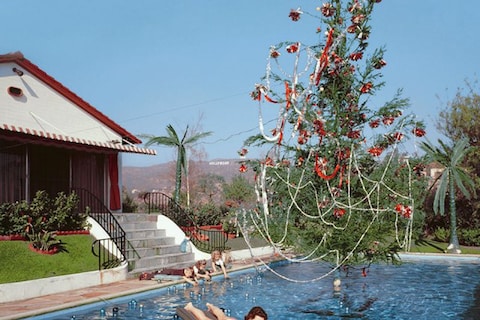 Rita Aarons, wife of the photographer, floating in a pool fe