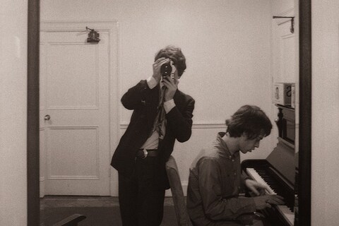 The photographer Michael Cooper with Mick Jagger at the pian