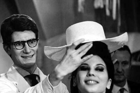 Yves Saint Laurent adjusting a model&#39;s hat