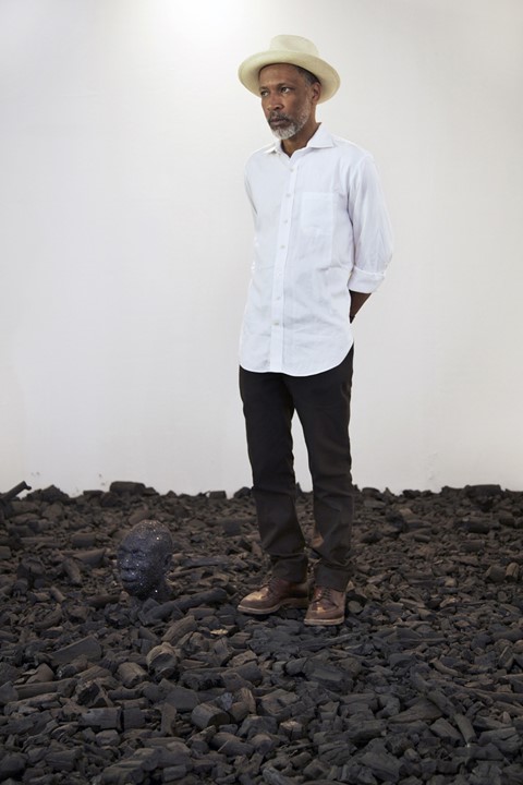 Radcliffe Bailey standing in his piece entitled Storm at Sea