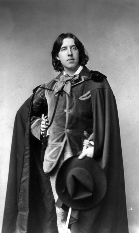 Oscar Wilde in cape and hat