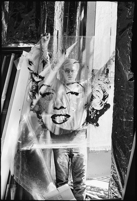 Andy Warhol holding the “Marilyn” acetate used to make his f
