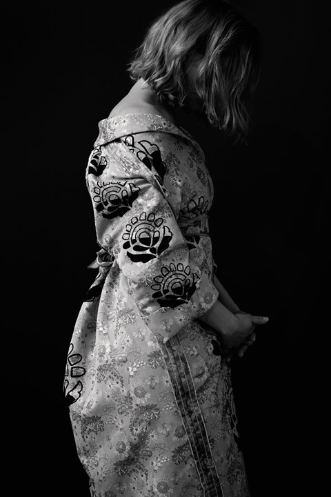 L&#233;a wears embroidered silk jacquard coat by Prada; silk scar