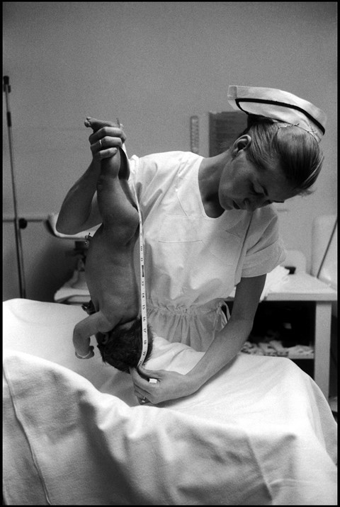 Nurse measures a newborn baby