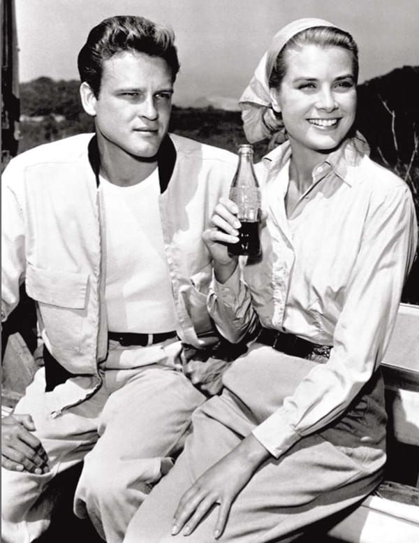 Actress Grace Kelly drinking Coca-Cola and actor John Ericso