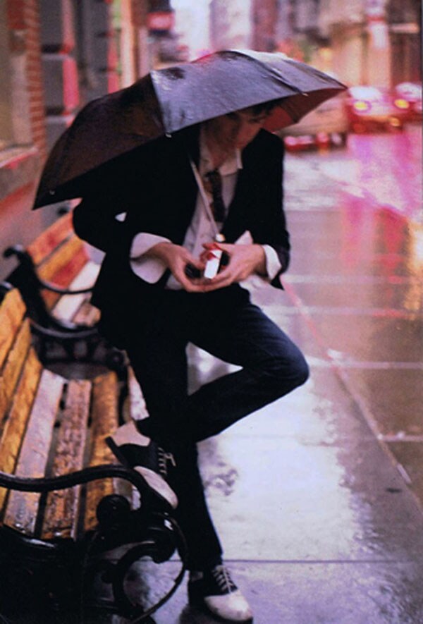 Tommy lighting up in the rain, New York City 2008