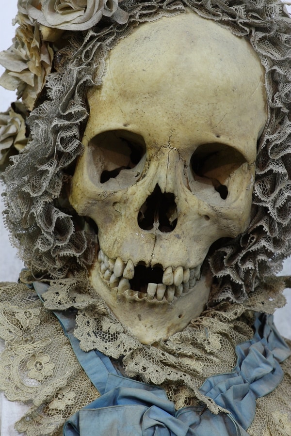 A bonneted figure at the Crypt of the Santa Maria Della Pace