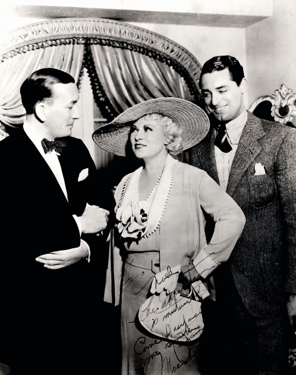 Noel Coward in a signed photograph with Mae West and Cary Gr
