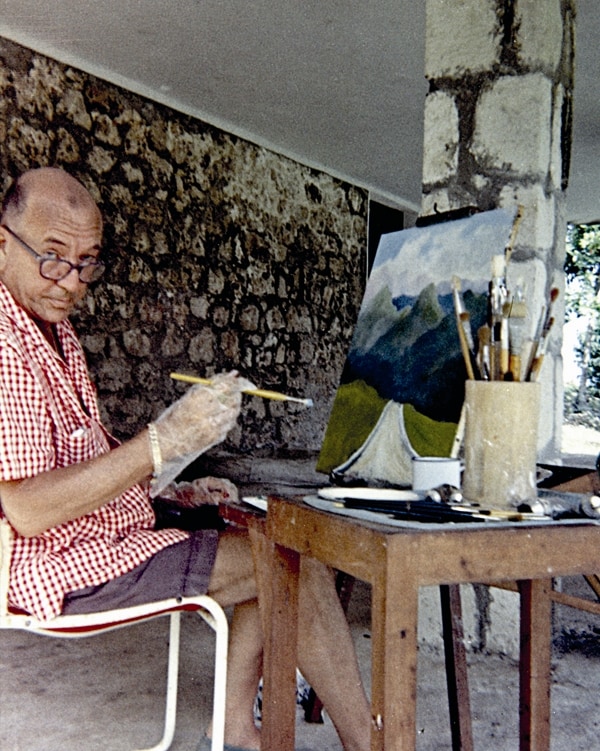 Noel Coward painting at his house in Jamaica