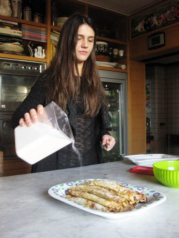 Margherita sprinkling the Palatschinken with sugar