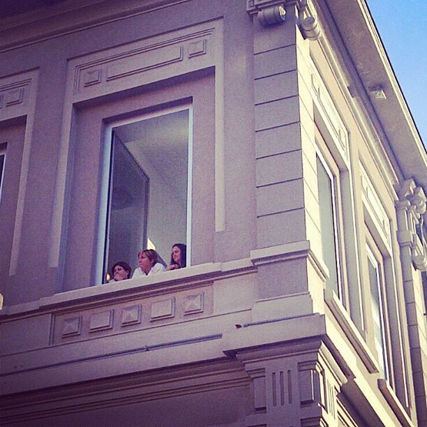 The Prada seamstresses watching guests arrive at the show, M