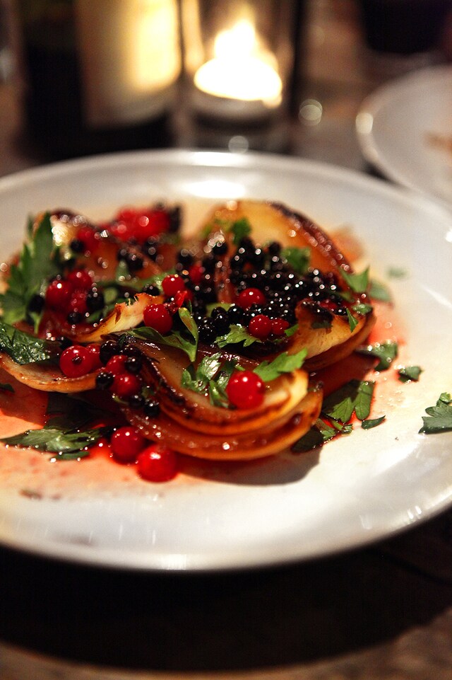 Grilled onions with pickled elderberries and redcurrants