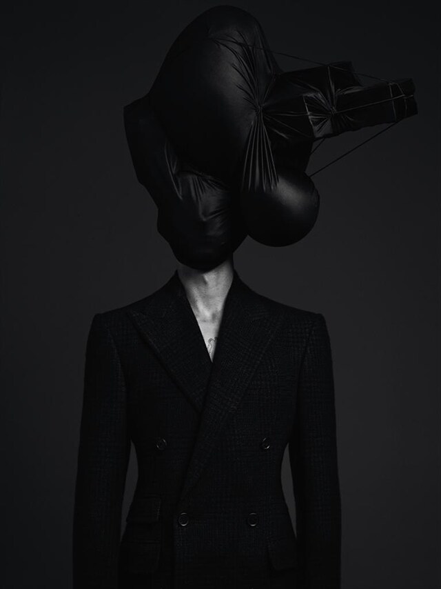 Sculptured headpiece by Soren Back; Double-breasted suit jac