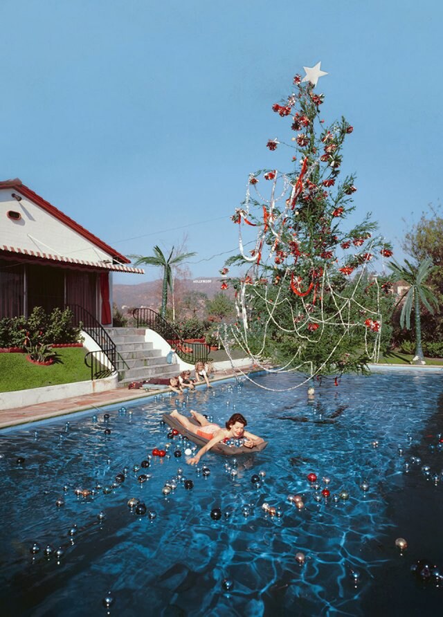 Rita Aarons, wife of the photographer, floating in a pool fe