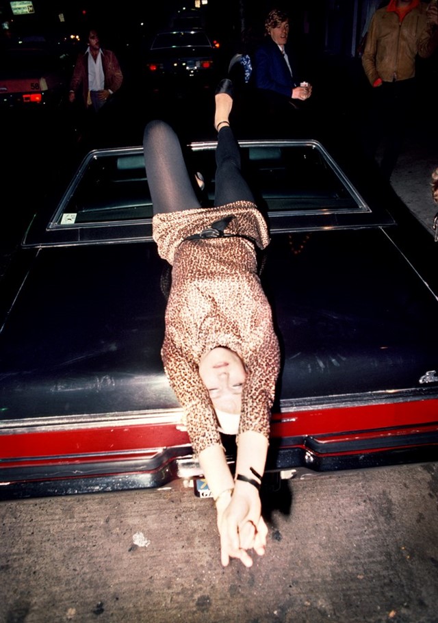 040_Woman_reclining_on_car_1977