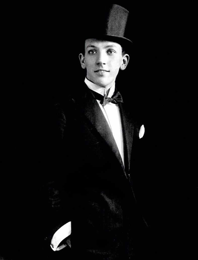 A young Noel Coward in top hat and tails