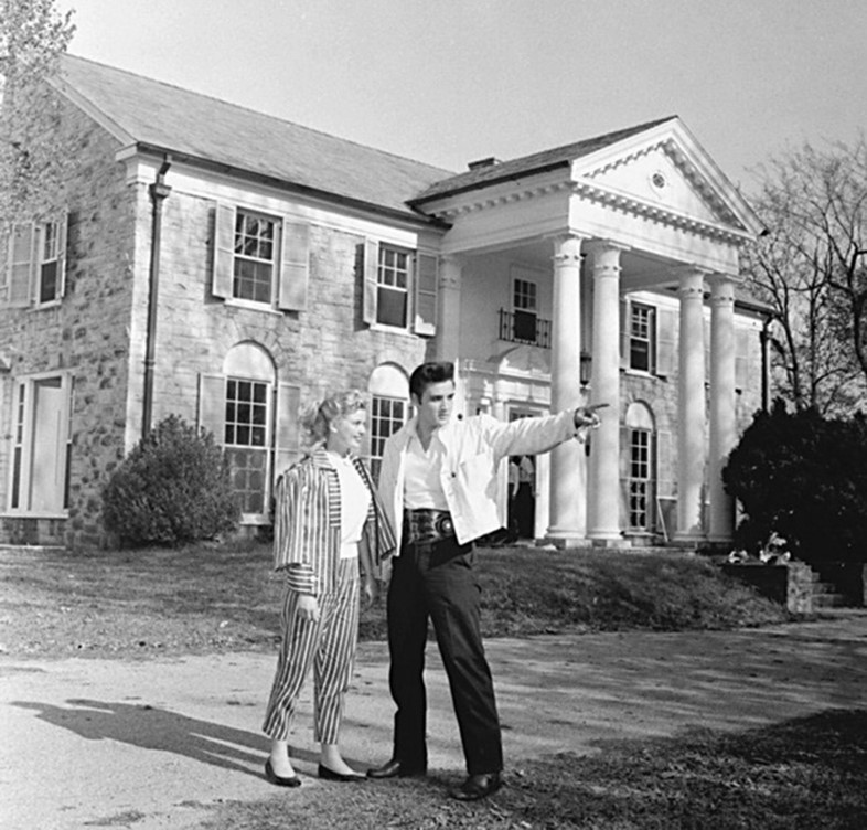 Elvis and a female friend outside his home Graceland in 1957