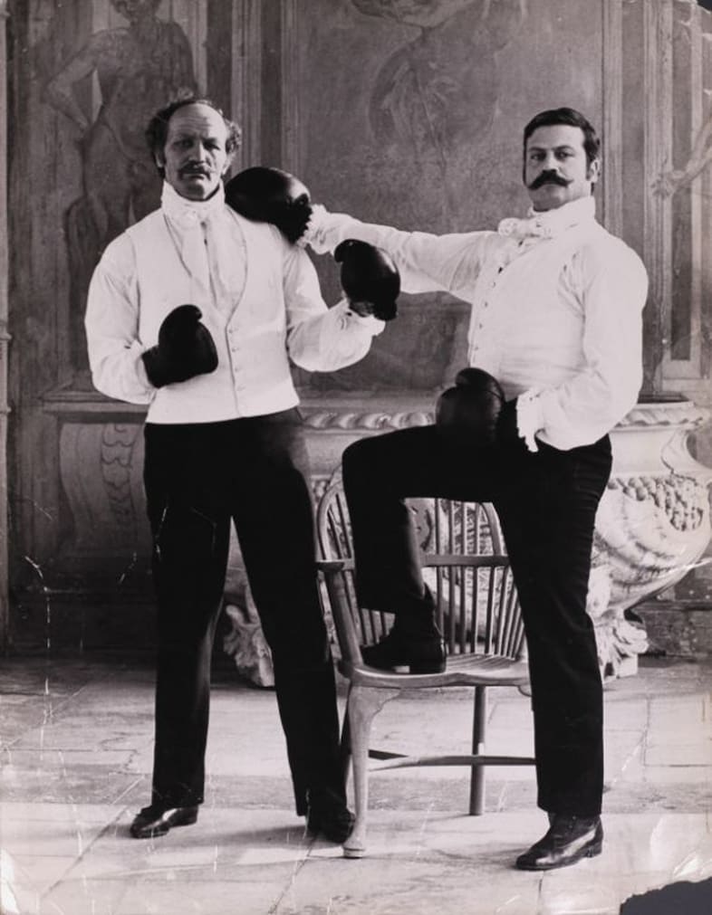 Henry Cooper and Oliver Reed on the set of Royal Flash, Lond