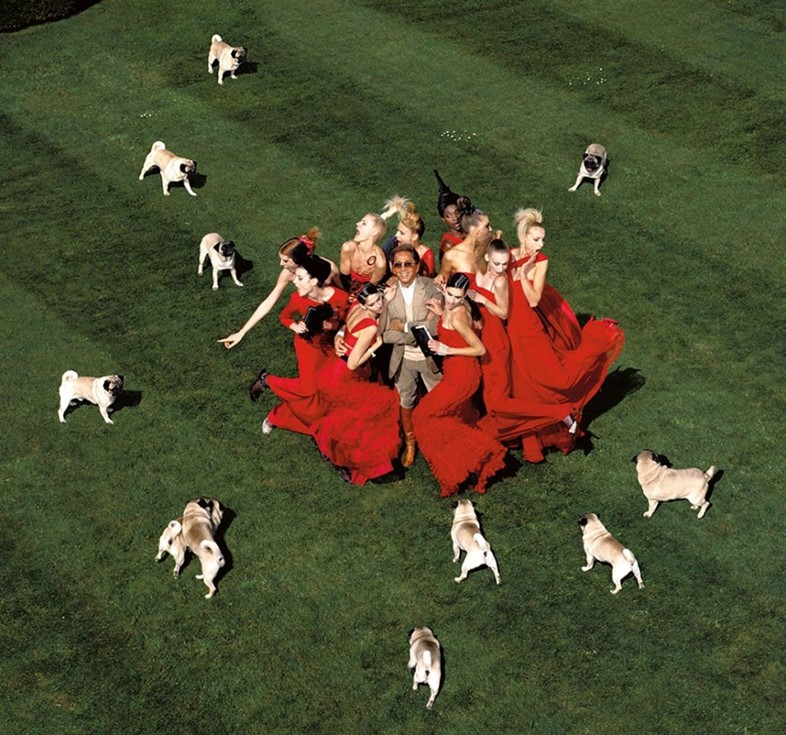 Valentino surrounded by models and pugs, by Jean Paul Goude 