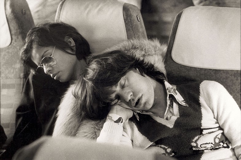 Singer Mick Jagger of the Rolling Stones sleeping alongside 